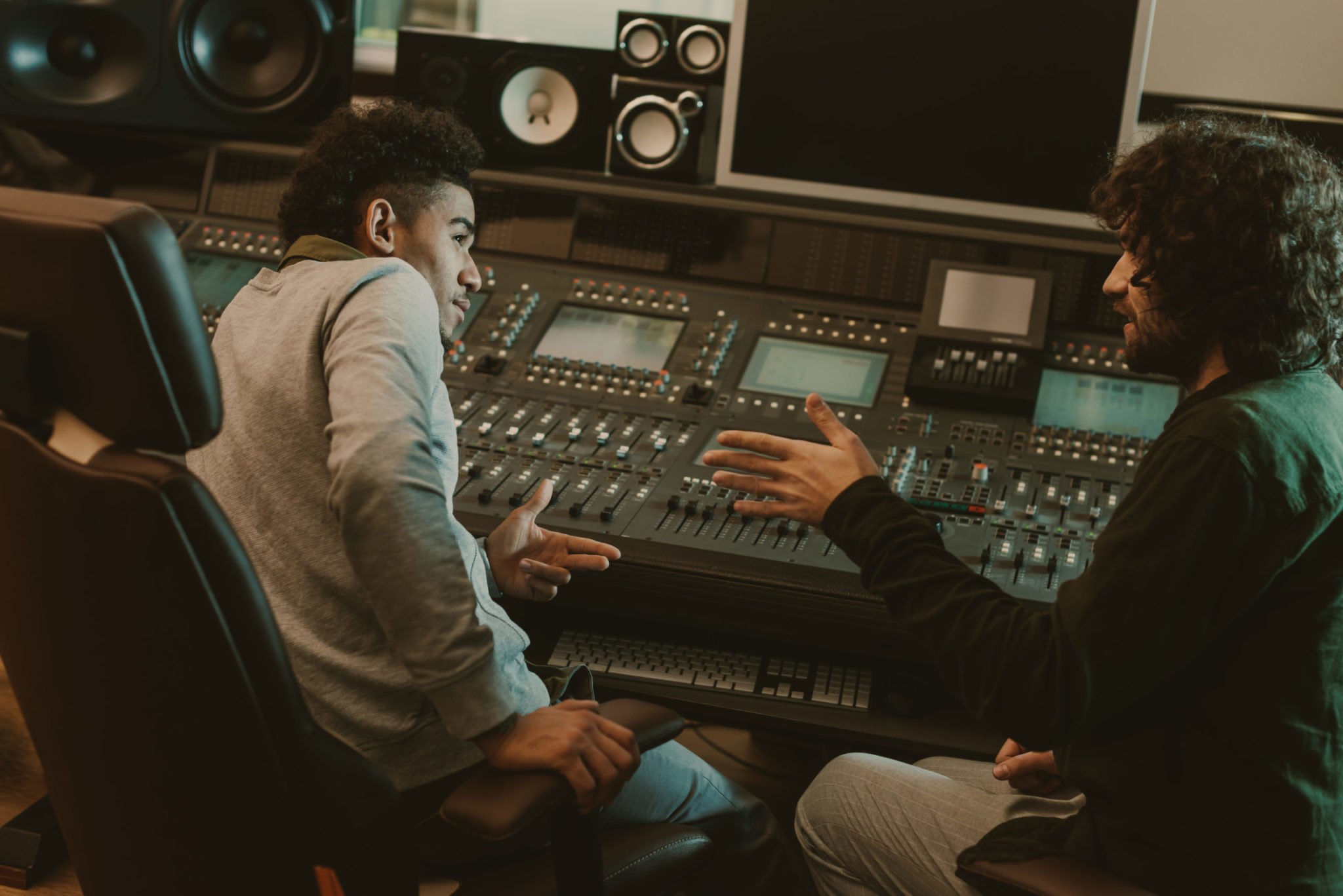 young musicians talking at recording studio