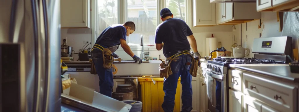 a team of professionals in los angeles carefully installing new, modern appliances in a renovated kitchen.