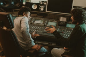 young musicians talking at recording studio
