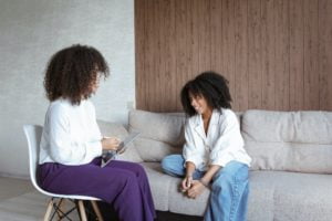 a couple of women sitting on a couch
